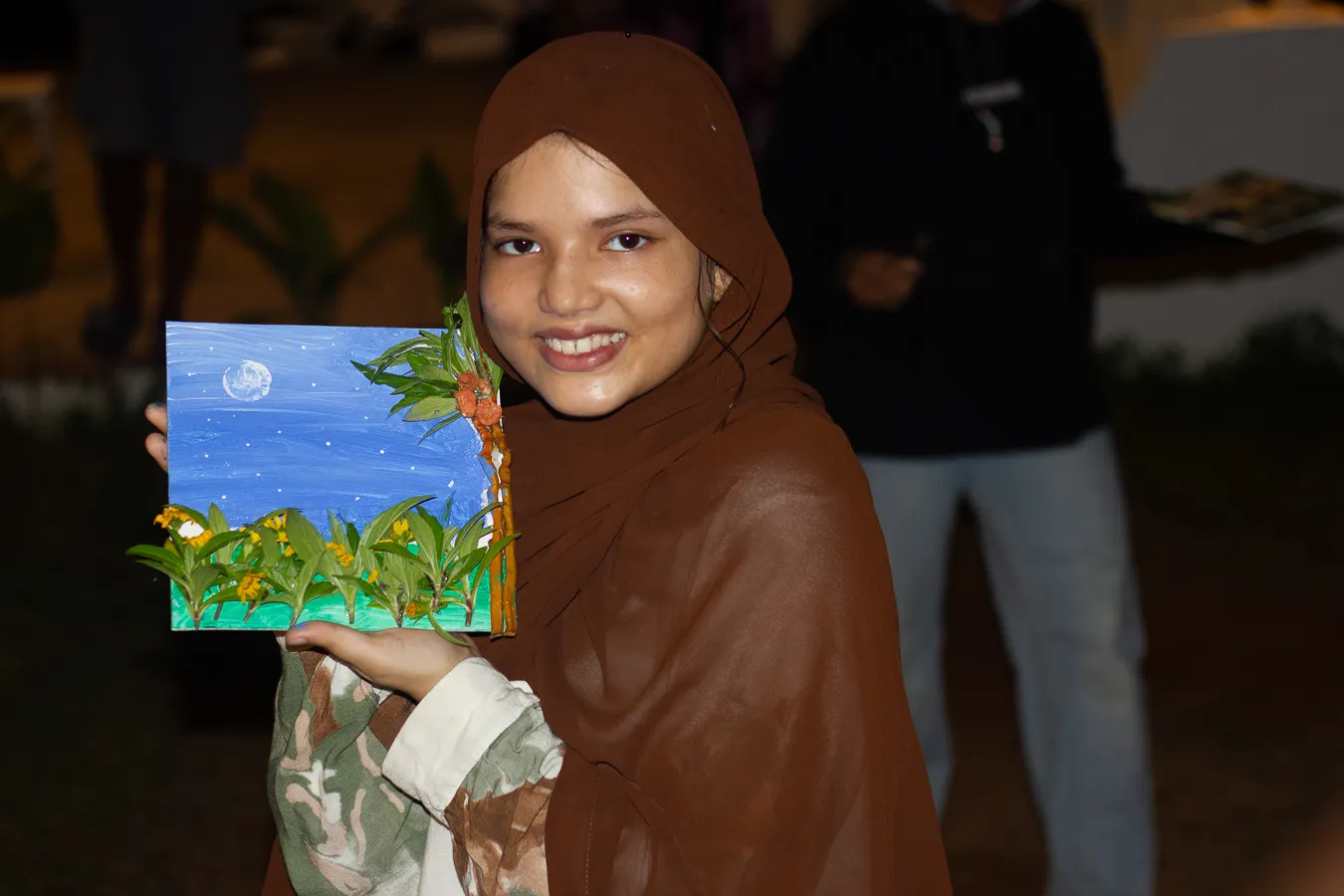 Girl smiling and displaying her art form