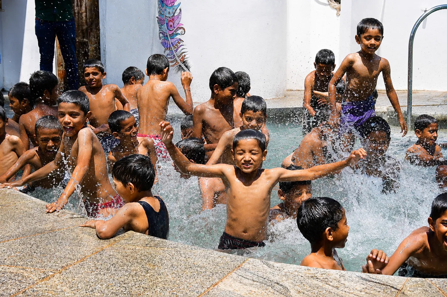 Young kids playing in the pool