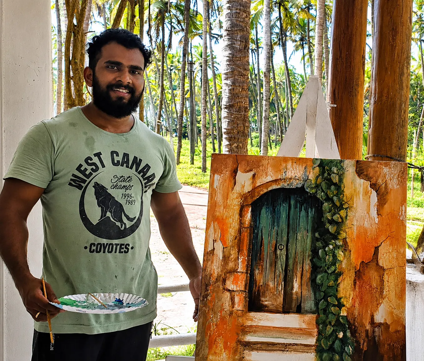 Male artist w. his work