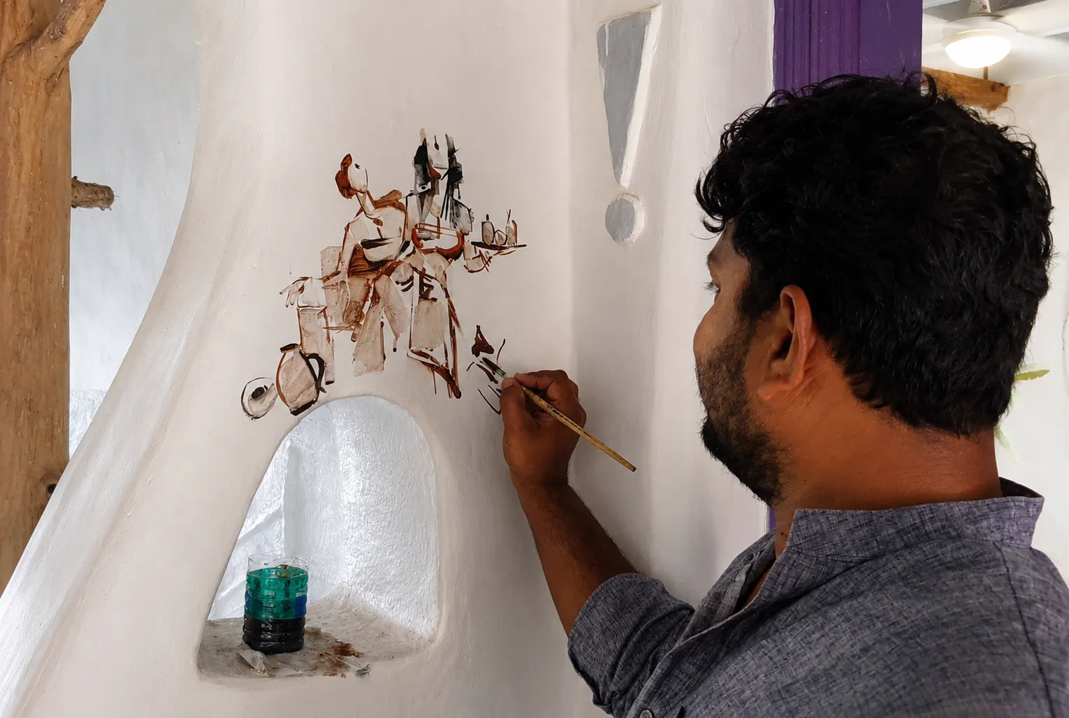 Male artist w. his work