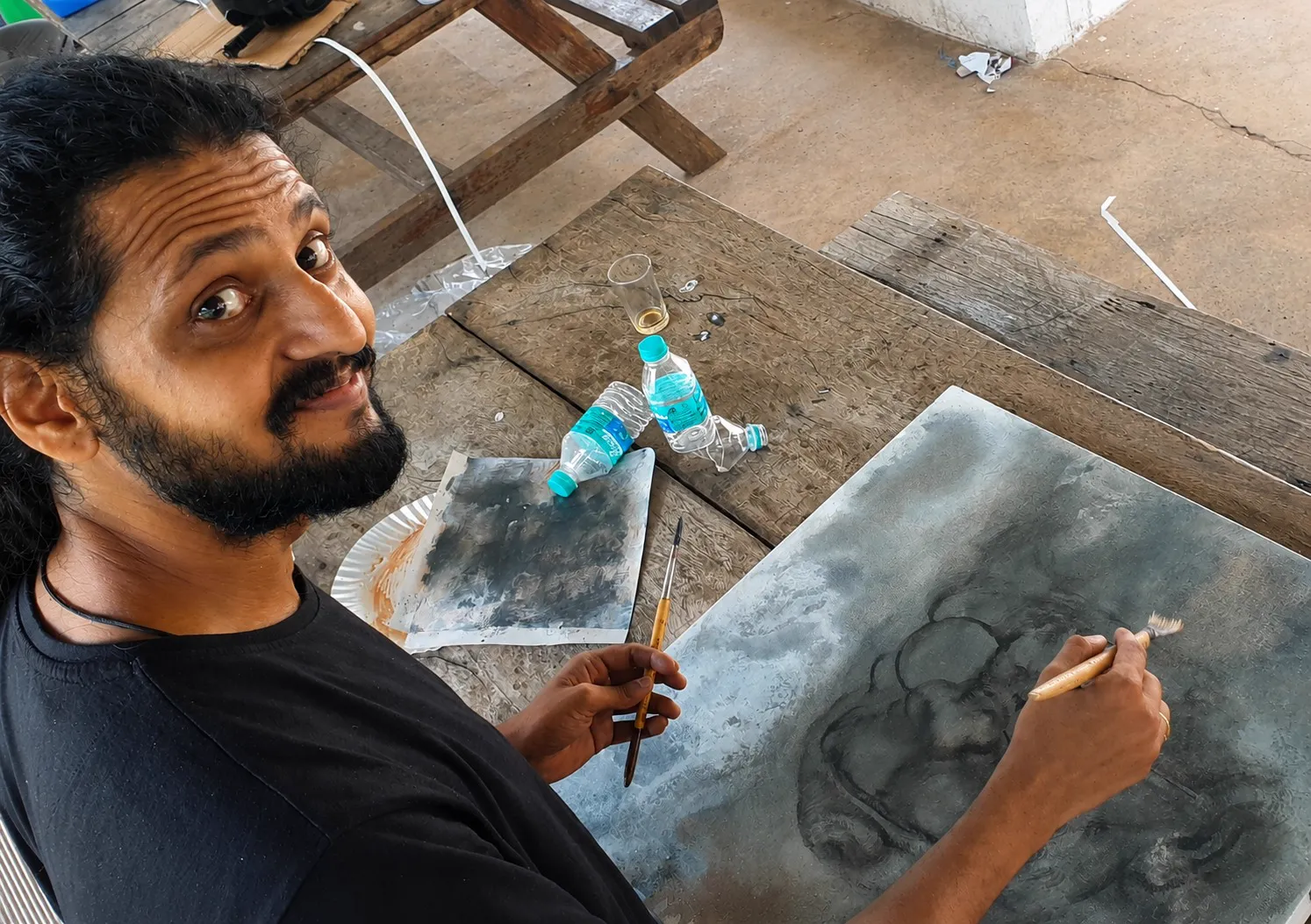 Male artist w. his work